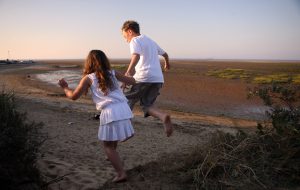 children playing in the sand dunes